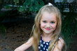 © NatBud - little blonde girl. Portrait of a beautiful smiling girl outdoor. Summer portrait of a smiling girl.
