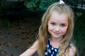 little blonde girl. Portrait of a beautiful smiling girl outdoor. Summer portrait of a smiling girl. 