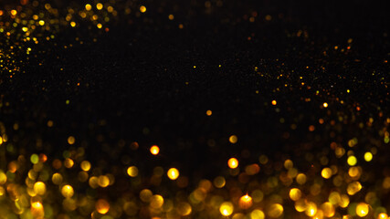 Abstract holiday background, gold Stardust on black.