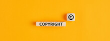 The Word Copyright And Copyright Symbol On Wooden Blocks. Concept Of Patenting. Or Copyright Protection.