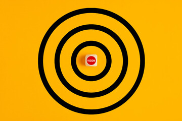 Poster - Target with the word vision written on a wooden block as the bulls eye on yellow background. Concept of aiming at the vision or business goals