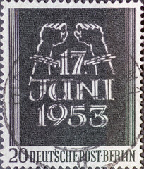 Wall Mural - GERMANY, Berlin - CIRCA 1953: a postage stamp from Germany, Berlin showing bound hands break the chains and inscription June 17th. Memory of the June 17, 1953 uprising. color: black.