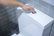 Hand Press And Flush Toilet. Cleaning, Lifestyle And Personal Hygiene Concept