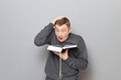 © Andrei Korzhyts - Funny shocked man is reading something extraordinary in book