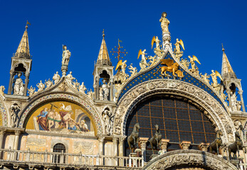 Wall Mural - St Mark`s Basilica or San Marco close-up, Venice, Italy. It is top landmark in Venice. Beautiful ornate exterior of medieval basilica, detail of luxury facade