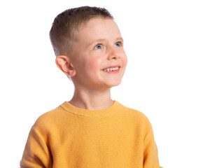 portrait of a cute 6-year-old boy on a white background, side view, look up. a beautiful and happy e