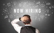 © ra2 studio - Rear view of a businessman with NOW HIRING inscription, modern business concept