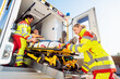 © Kzenon - Paramedics putting injured man on stretcher in ambulance car