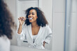 Pleased curly-headed pretty lady brushing her teeth