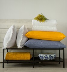 Wall Mural - Yellow and white decorative pillows and blankets in the bedroom