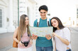 © AntonioDiaz - Tourists Reading Map In City