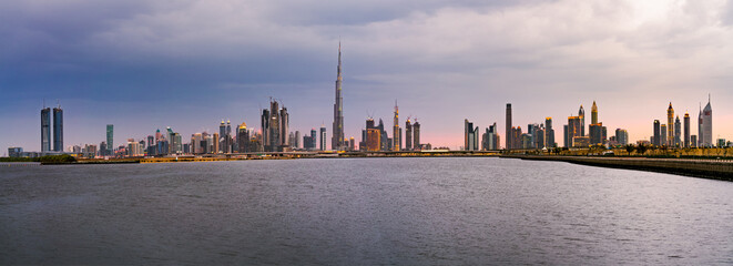 Wall Mural - Sunset skyline panorama of Dubai with reflection, UAE