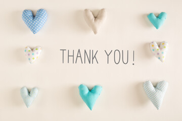 Sticker - Thank You message with blue heart cushions on a white paper background