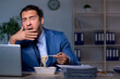 © Elnur - Hungry employee working late in the office