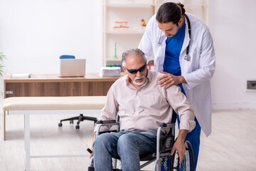 Old blind man visiting young male doctor