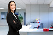 © Minerva Studio - Smiling businesswoman portrait in a modern office