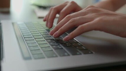 Fototapete - close-up of woman hands typing on laptop keyboard on the table.