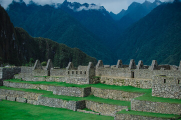 Photo of stone wall with mountains in the background.