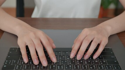 Fototapete - close-up of woman hands typing on laptop keyboard on the table.