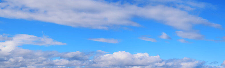 bright blue sky with white clouds, illuminated by the sun. beautiful summer landscape.wide format, p