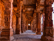 Columns With Stone Carving In Courtyard Of Quwwat-Ul-Islam Mosque, Qutub Minar Complex. It Is UNESCO World Heritage Site At  New Delhi,India