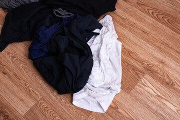 Pile of dirty clothes on wooden floor