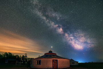 Wall Mural - Under the bright Milky Way, Mongolia yurts on the grassland are scattered.