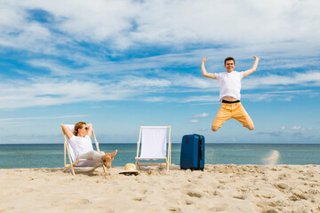 Wall Mural - Woman and man relaxing on beach