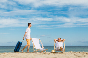 Wall Mural - Woman and man relaxing on beach