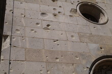 Traces Of Bullets And Splinters On The Wall Of The Building After Shelling The City 