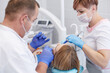 © lenetsnikolai - Doctor dentist treats teeth of a beautiful young girl patient. The girl on reception at the dentist. Doctor dentist treats tooth