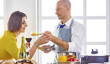 © lenetsnikolai - Smiling young couple cooking food in the kitchen