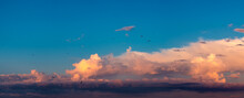 Blue Sky Background With Birds And Orange Clouds