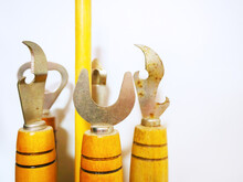 Closeup Photo Of A Vintage Set Of Openers Of Various Shapes With Yellow Wooden Handles
