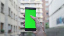 NEW YORK - June 19, 2020: Man Young Hand Uses Holding A Mobile Telephone With A Vertical Green Screen In Downtown Chroma Key Smartphone Technology Cell Phone Street Touch Message Display