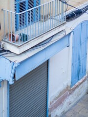 Sticker - Old building with blue doors and windows and a balcony