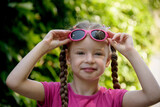 Fototapeta Młodzieżowe - little Caucasian girl with sunglasses