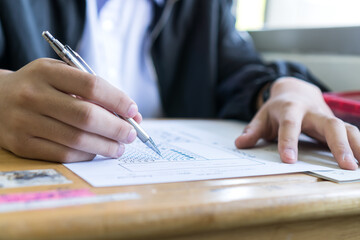 Wall Mural - boy hands student testing in exam on exercise taking at high school or university in test room. writ