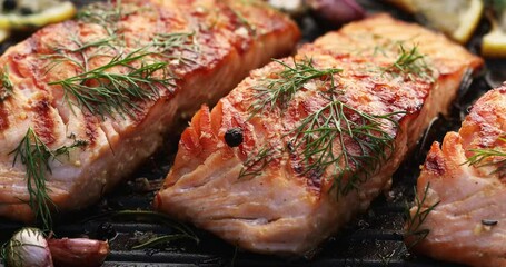 Wall Mural - Grilled salmon fillets on a grill plate drizzled with lemon juice
