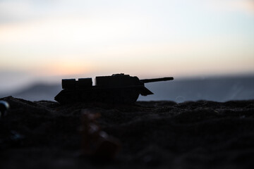 War Concept. Military silhouettes fighting scene on war fog sky background, World War Soldiers Silhouette Below Cloudy Skyline At sunset.