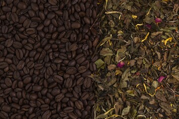 Close up macro view of coffee beans and white tea leaves isolated. Drinks concept texture background.