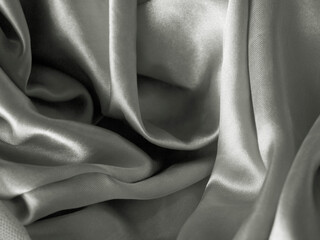Smooth elegant grey silver silk or satin texture can use as background. silver fabric texture close up