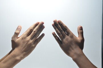 Wall Mural - Folded Praying Hands of two person in white background