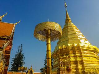 Wall Mural - Beautiful northern Thai style architectural of golden pagoda with golden umbrella at Wat Phra That Doi Suthep, the famous temple and became the landmark of Chiang Mai, Thailand.