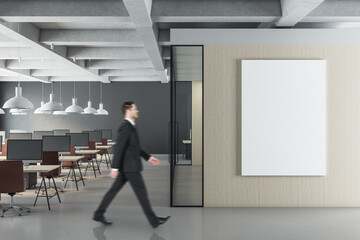 Canvas Print - Businessman walking in modern office interior