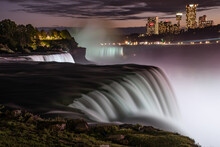 Long Exposure Of Niagara Falls In Evening, Illuminated With White Light From Canadian Side, Buffalo NY 