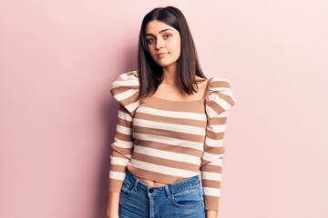 Young beautiful girl wearing casual clothes standing over isolated pink background