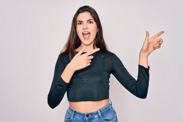 Sticker - Young beautiful brunette woman wearing casual sweater and jeans standing over isolated background smiling and looking at the camera pointing with two hands and fingers to the side.