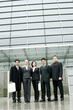 © ImageHit - A group of business people standing in front of their office building