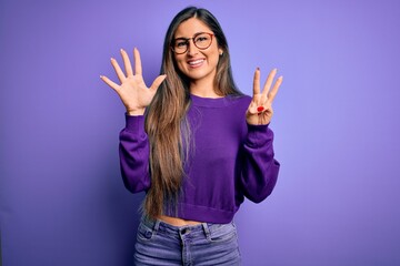 Wall Mural - Young beautiful smart woman wearing glasses over purple isolated background showing and pointing up with fingers number eight while smiling confident and happy.